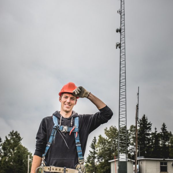 Telecom Technician man in uniform with harness